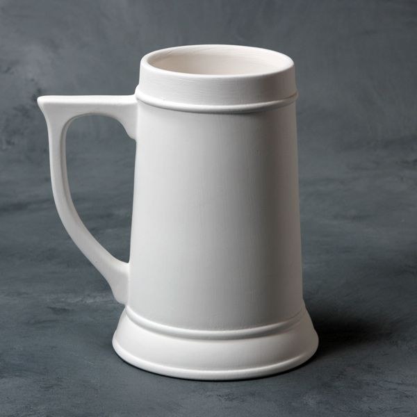 A white stein without paint on it, against a grey background